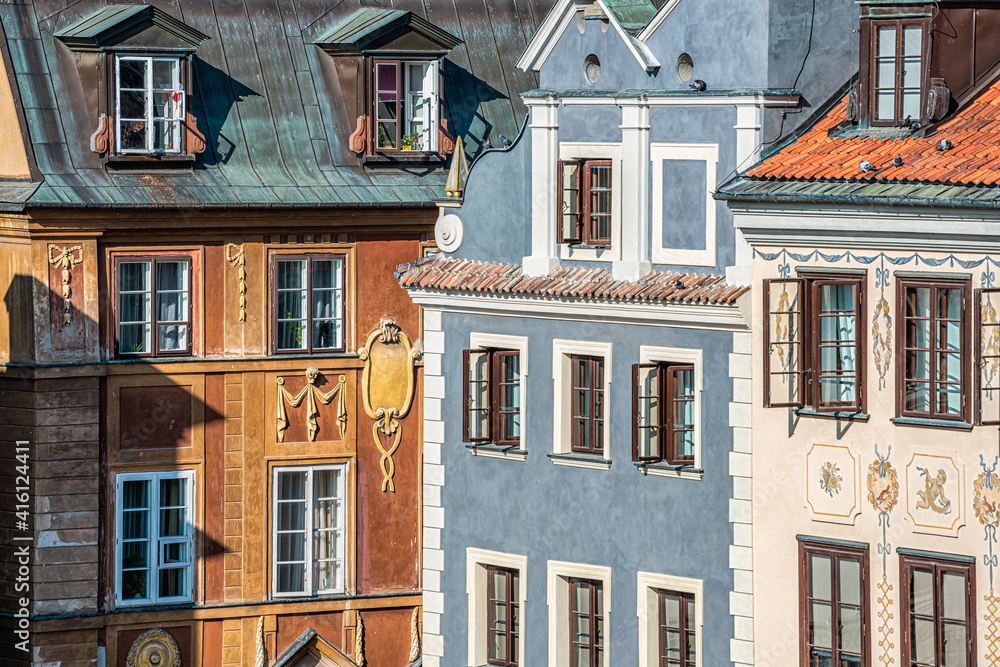 Fototapeta premium Warsaw, Poland rynek old town market square with historic architecture of wall corner with windows closeup pattern of blue and brown colors