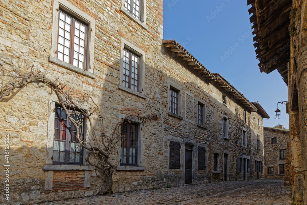 PEROUGES, FRANCE, February 23, 2021 : A street of the old medieval town. The town was restored and houses were saved in the beginning of 20th century and is now a popular tourist attraction.