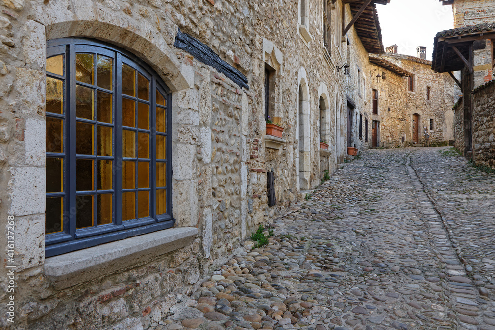 PEROUGES, FRANCE, February 23, 2021 : A street of the old medieval town. The town was restored and houses were saved in the beginning of 20th century and is now a popular tourist attraction.