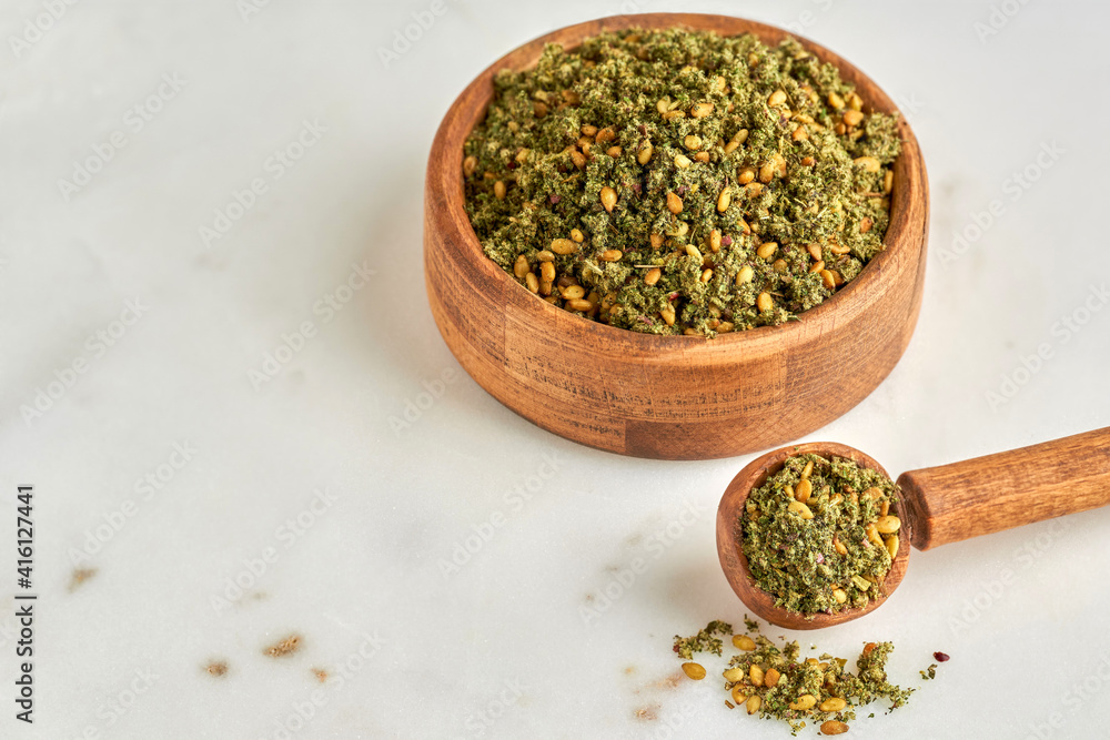 Mixed spice zaatar or zatar in wooden bowl  . Closeup