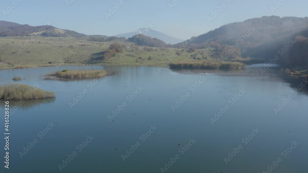 Lake Biviere in the heart of the Nebrodi mountains in Sicily. Lake in autumn with a view of the Etna volcano and the background of the Rocche del Crasto, the Tyrrhenian sea and the Aeolian Islands. Lake Biviere in the heart of the Nebrodi mountains in Sicily. Lake in autumn with a view of the Etna volcano and the background of the Rocche del Crasto, the Tyrrhenian sea and the Aeolian Islands.