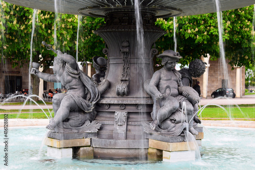 Working fountain with figures of children and fish in the city Park