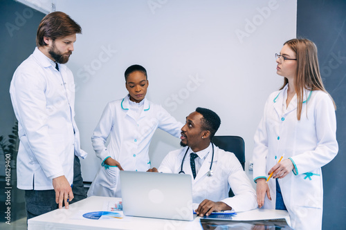 The medical team checks the results of x-rays on a laptop in the