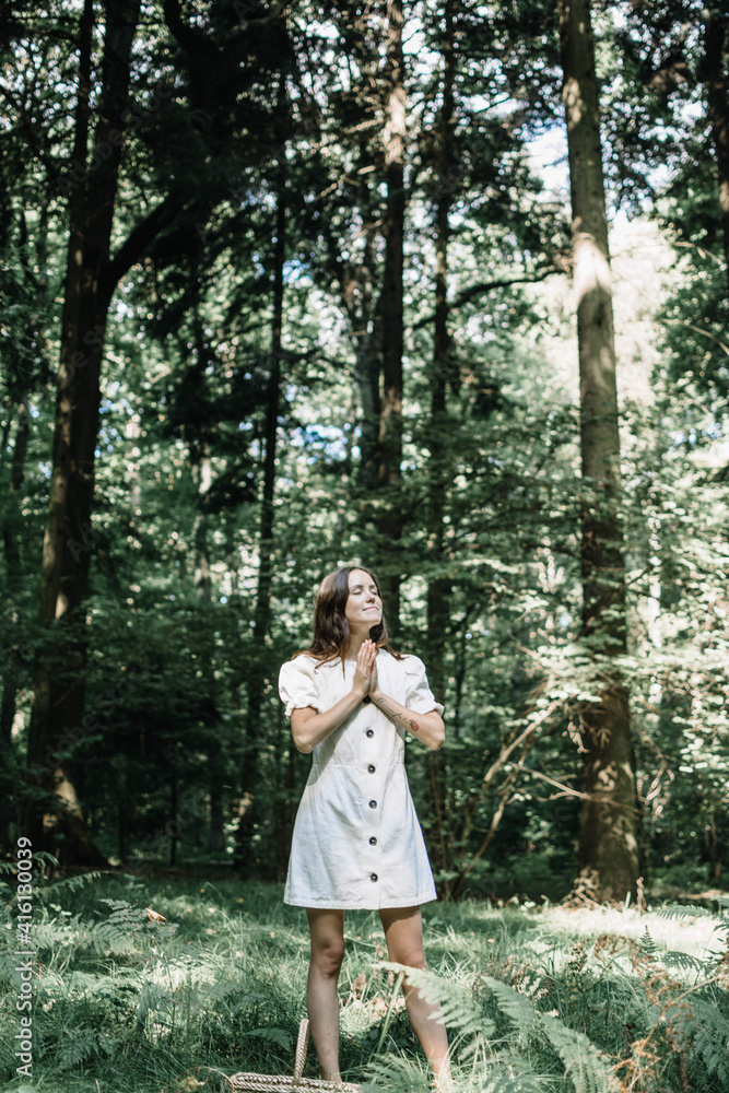 The girl smiles beautifully. A young girl in a white dress. Namaste