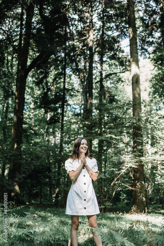 A young girl in a white dress. The girl smiles beautifully. A beautiful smile