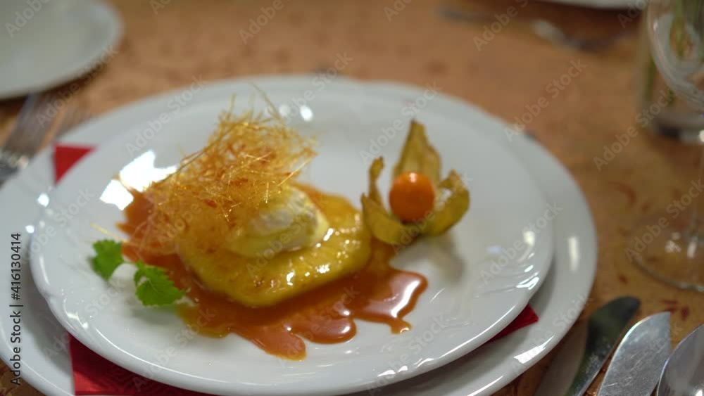sweet dessert with pineapple, vanilla ice cream, caramel, spun sugar decoration and physalis sweet dessert with pineapple, vanilla ice cream, caramel, spun sugar decoration and physalis