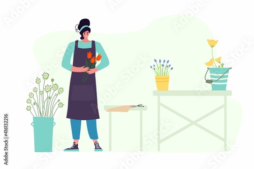 Woman compose bouquet on table. Forist shop or store.