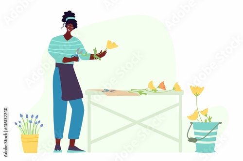 Woman compose bouquet on table. Forist shop or store.
