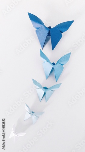 Overhead photo of blue origami butterflies