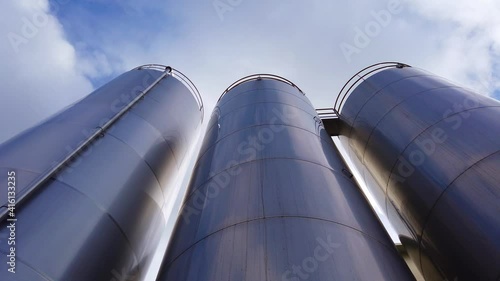 Large metal silo for storing raw material. Modern industrial plant.