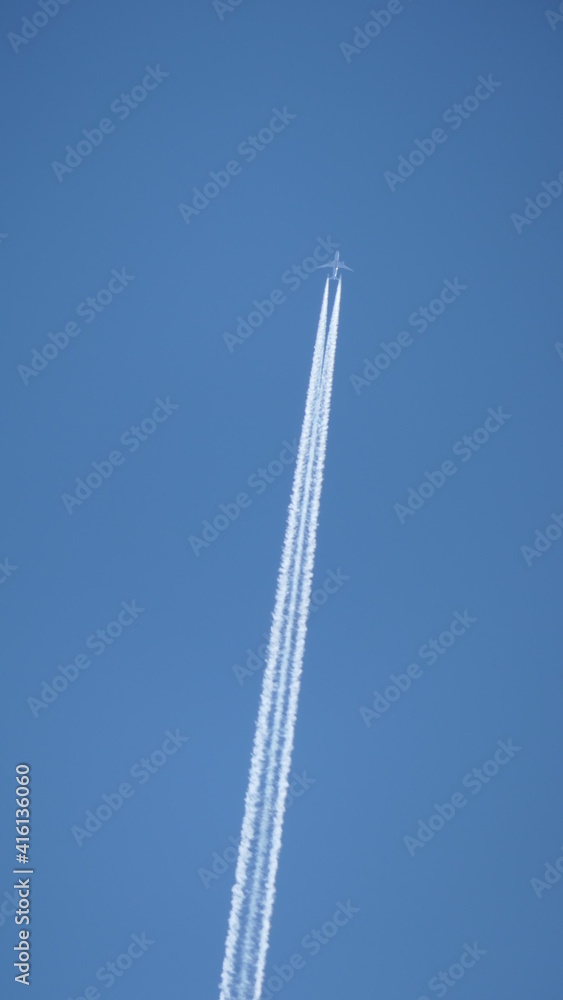 dynamic jetplane in the sky with trail against luminous blue sky dynamic jetplane in the sky with trail against luminous blue sky