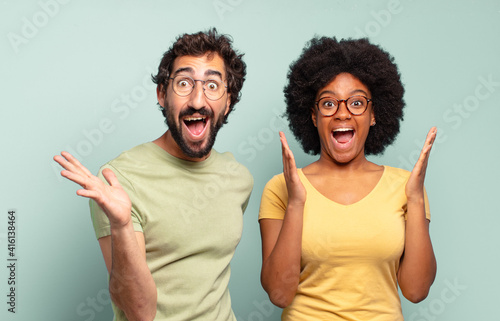 Obraz na plátne multiracial couple of friends feeling happy, excited, surprised or shocked, smil