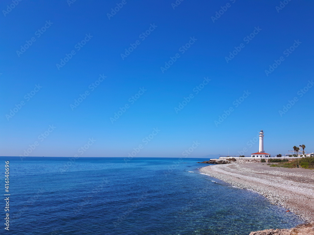 Panoramic view of the torrox lighthouse with the mediterranean sea in the background