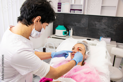 Cosmetology  lip augmentation  beauty injections in a beauty salon  close up