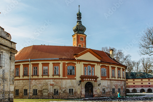Tourists in Libechov, old abandoned baroque castle in central Bohemia,Czech republic.Romantic building with tower,red facade and park.Rebuilt as Renaissance chateau surrounded by wide water moat.