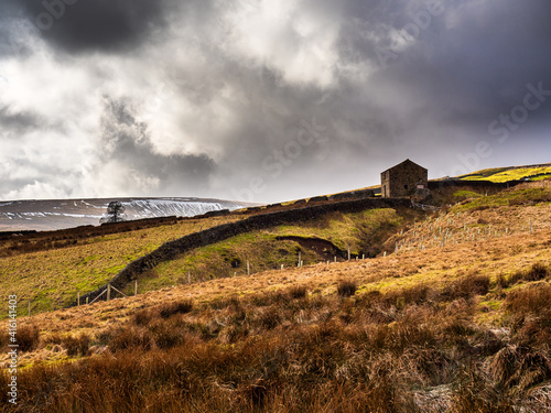 Slika na platnu Old deserted barn with moorland and Great Whernside mountain in the distance
