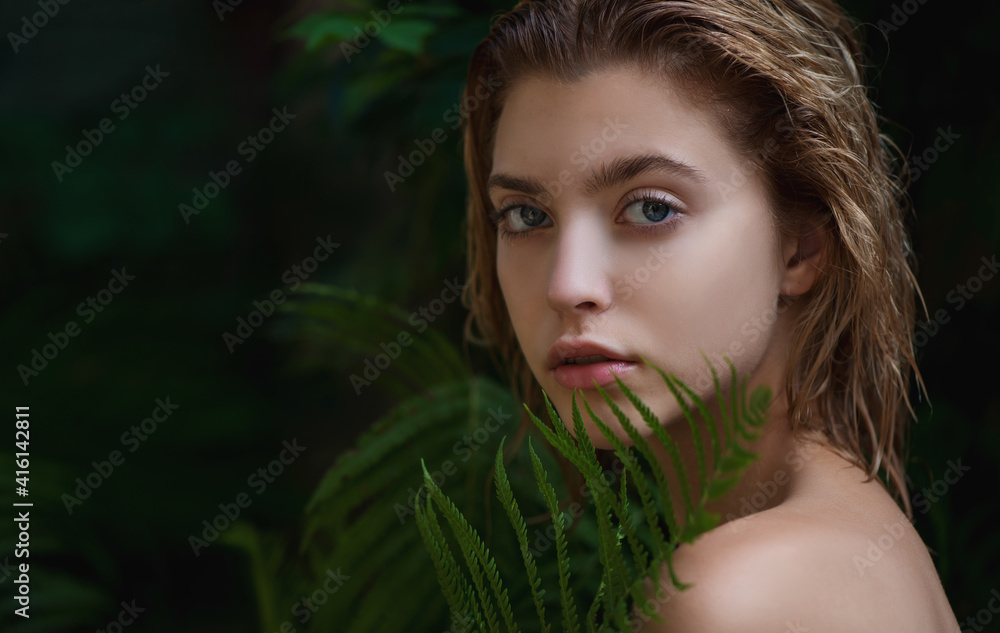 Beautiful young woman with perfect skin front of plant tropical green leaves background with fern. Beautiful young woman with perfect skin front of plant tropical green leaves background with fern.