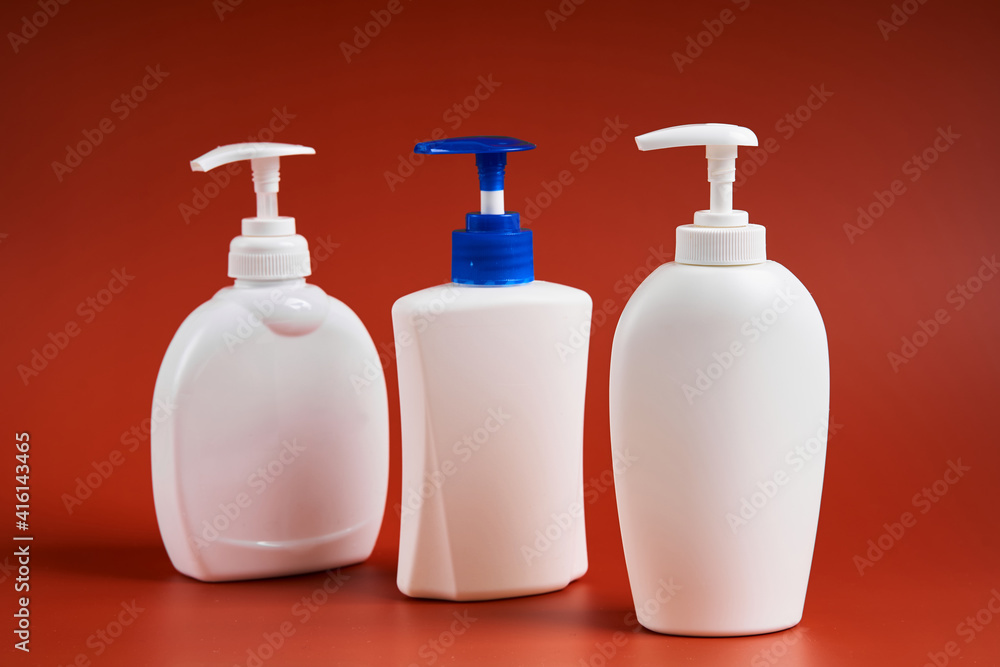 Set of three clean white plastic bottles with soap dispenser Set of three clean white plastic bottles with soap dispenser