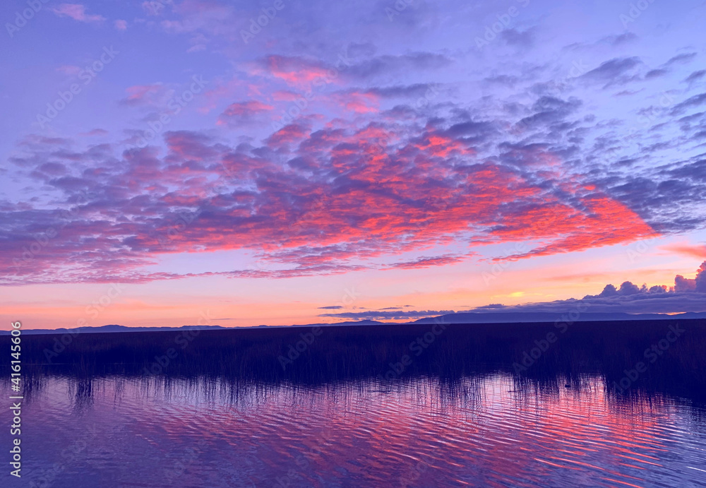 Fototapeta premium Sunset red sky over Titicaca lake, evening in Peru. silence, tranquility, serenity, relax, zen, meditation.