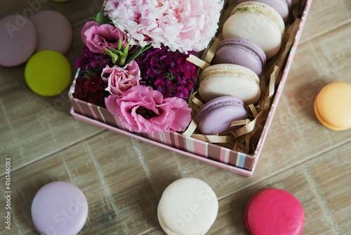 Set of colorful macaroon in the box with flowers.