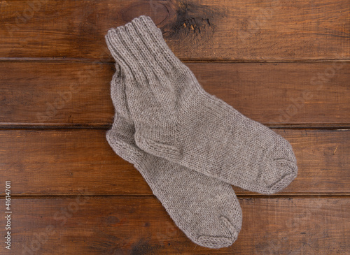 Top view on grey  socks on a wooden background. Close up.