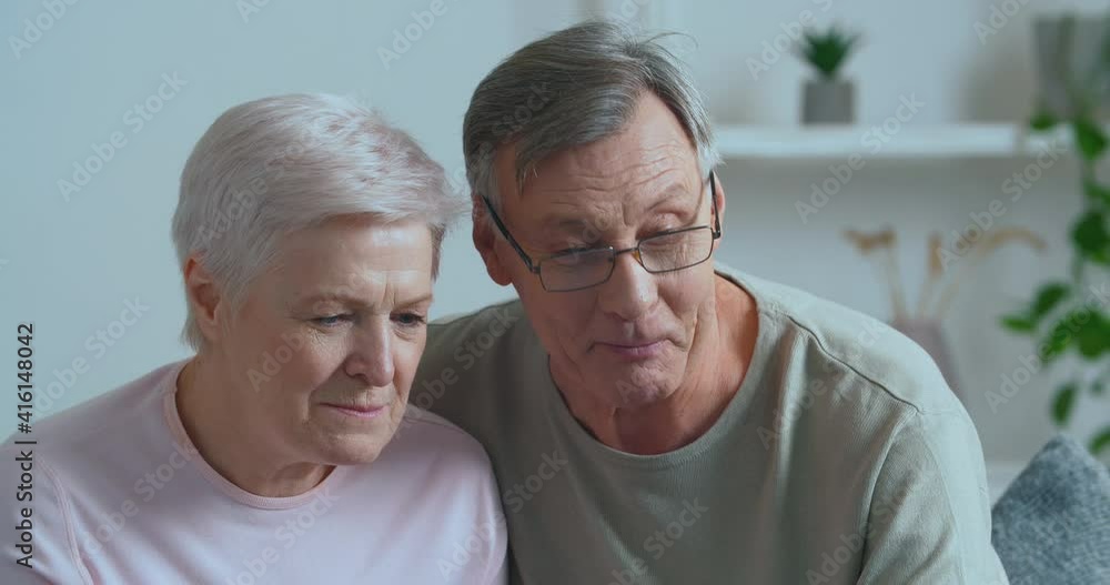 Elderly couple modern retirees family grandparents make video call from home talking to webcam communicate remotely with children, grandchildren or friends actively discussing news, technology concept Elderly couple modern retirees family grandparents make video call from home talking to webcam communicate remotely with children, grandchildren or friends actively discussing news, technology concept