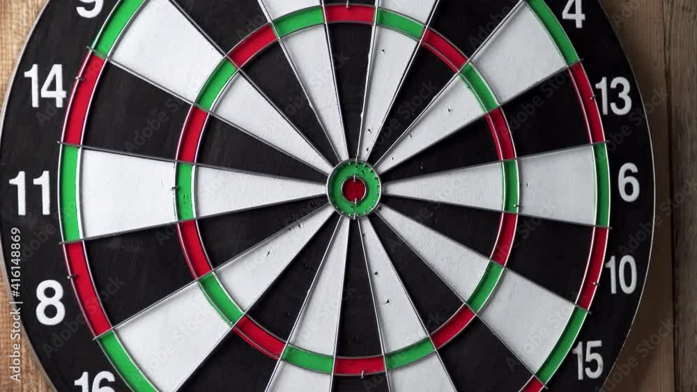 Darts game. Throwing darts at the target. Empty Dart board hanging on a wooden wall. Extra zoom in central part Darts game. Throwing darts at the target. Empty Dart board hanging on a wooden wall. Extra zoom in central part