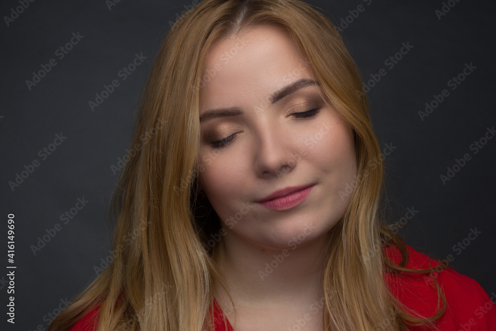 a blonde girl with an overweight plus size, a red overallposing on a dark Studio background