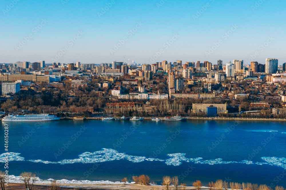 Panoramic view of Don river and right bank of Rostov-on-Don city with many buildings, Russian big city in winter time aerial view.