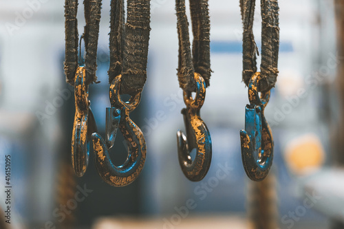 Wallpaper Mural Old yellow frayed hooks of a mobile crane on a blurred background of industrial premises. Torontodigital.ca