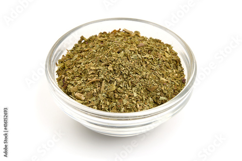 Dried basil herb, crushed basil, isolated on white background. High resolution image
