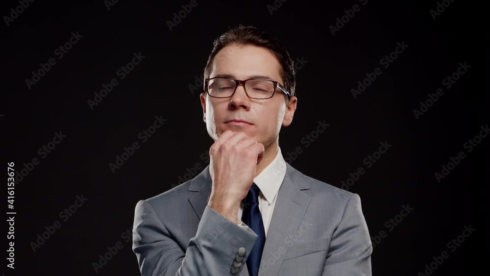 Studio portrait of successful and smart businessman in suit and tie. Man in formal wear over black background. Studio portrait of successful and smart businessman in suit and tie. Man in formal wear over black background.