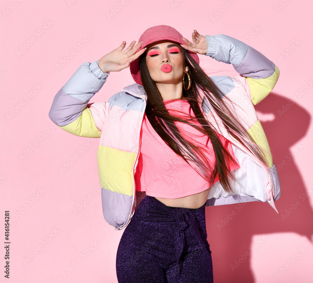 Stylish teenager girl model posing for camera beauty studio portrait isolated on pink background. Gorgeous young woman in a jacket, a T-shirt and a hat. Teenage and youth fashion Stylish teenager girl model posing for camera beauty studio portrait isolated on pink background. Gorgeous young woman in a jacket, a T-shirt and a hat. Teenage and youth fashion