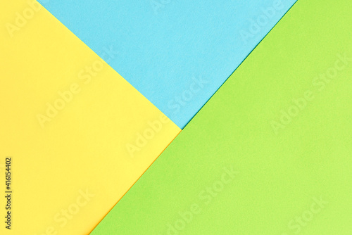 Blue yellow and green color paper geometric flat lay background