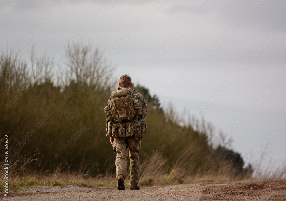British Army soldier completing an 8 mile tabbing exercise with fully loaded 25kg bergen
