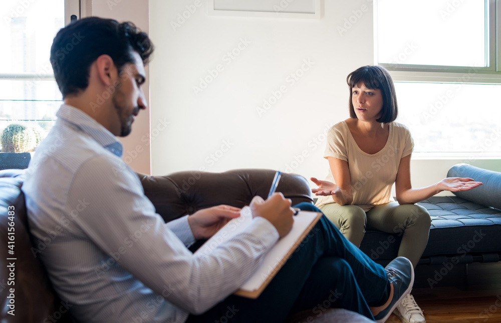 Psychologist talking with patient on therapy session. Psychologist talking with patient on therapy session.