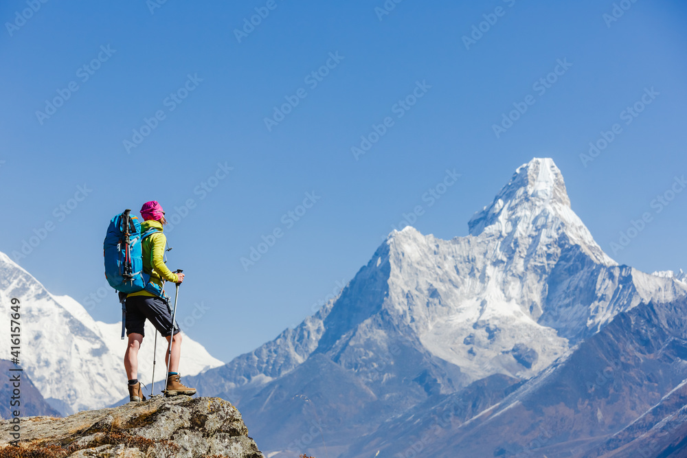 Hiking in Himalaya mountains. Woman Traveler with Backpack hiking in the Mountains. mountaineering sport lifestyle concept Hiking in Himalaya mountains. Woman Traveler with Backpack hiking in the Mountains. mountaineering sport lifestyle concept