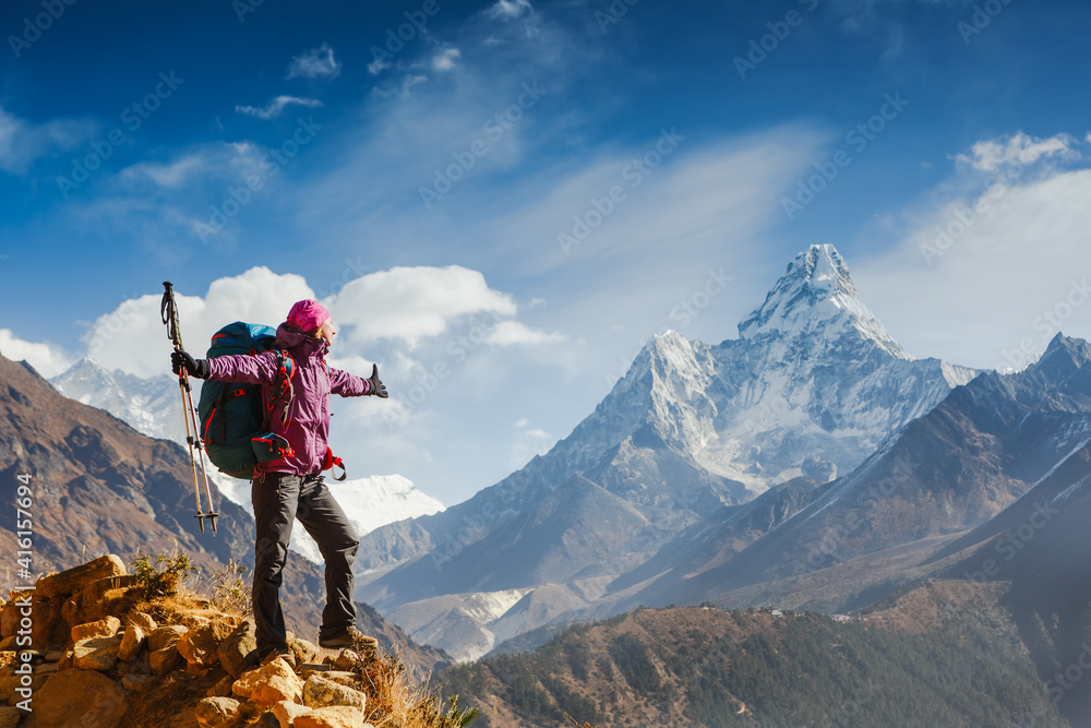 Woman Traveler with Backpack enjoying the mountains in Himalayas