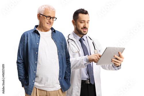 Male doctor showing a digital tablet to a mature male patient