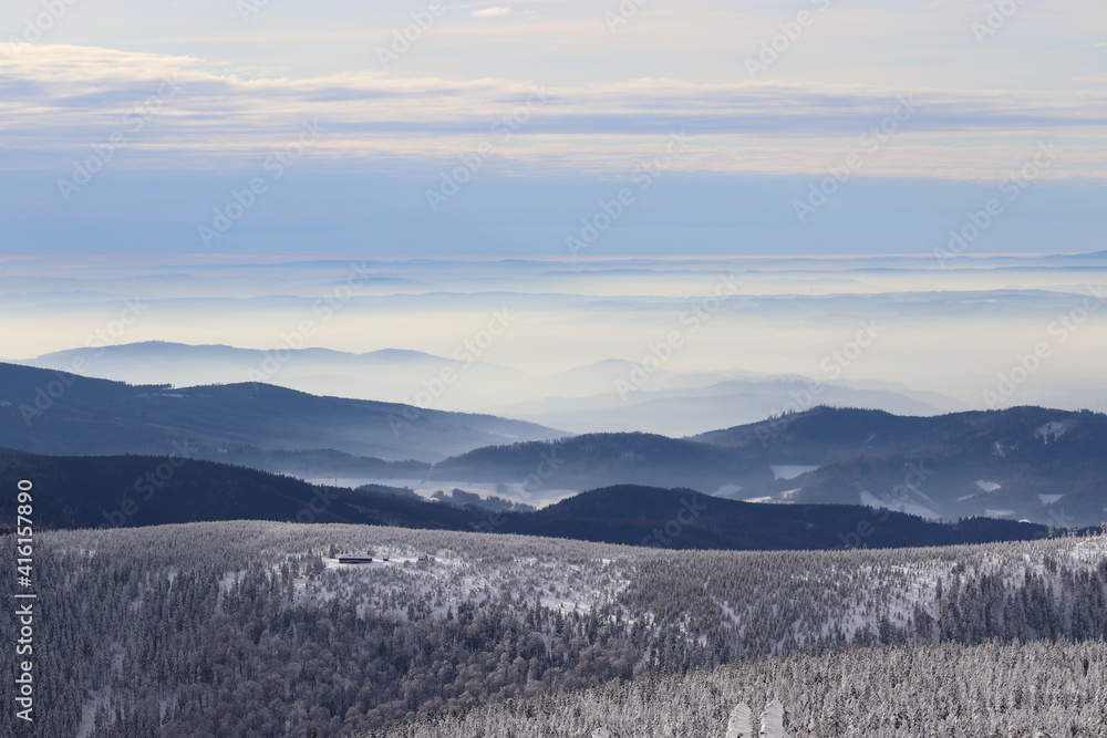 A view from the peak of the mountain Praded to the landscape in haze in Jeseniky, Czech republic A view from the peak of the mountain Praded to the landscape in haze in Jeseniky, Czech republic