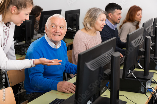 Portrait of smiling senior man during computer classes for elderly people at university of third age