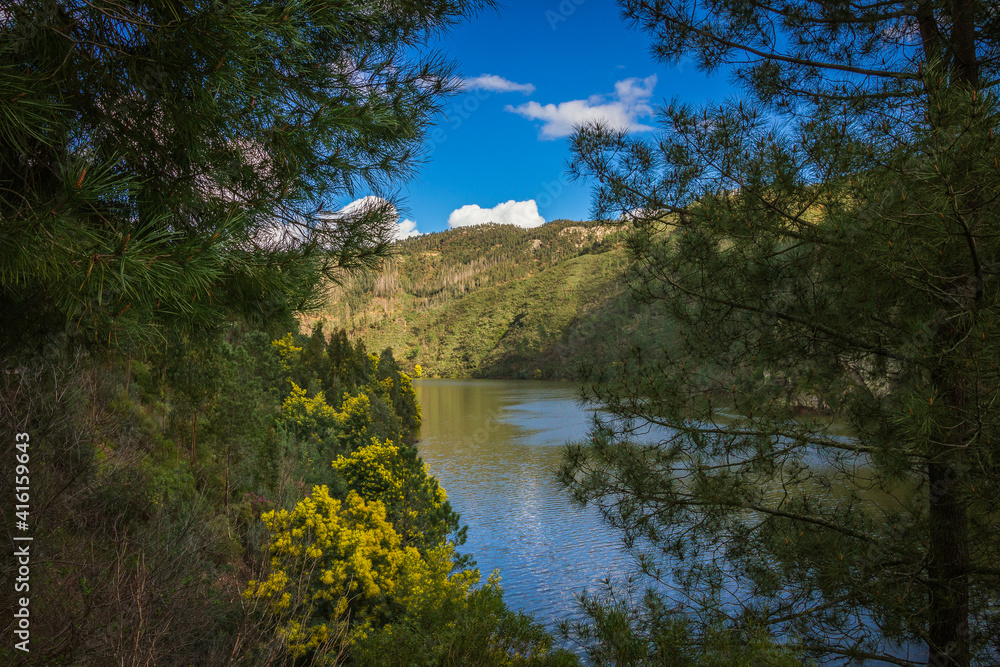Landscape view of the lake with mountains background and beautiful clouds on the sky. Landscape view of Zezere river in Aldeias de Xisto, Portugal