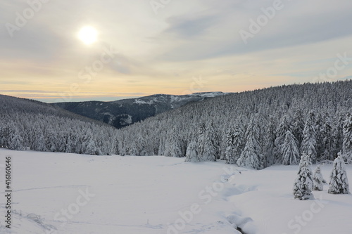 The sun going down in the snowy mountains at Jeseniky, Czech republic