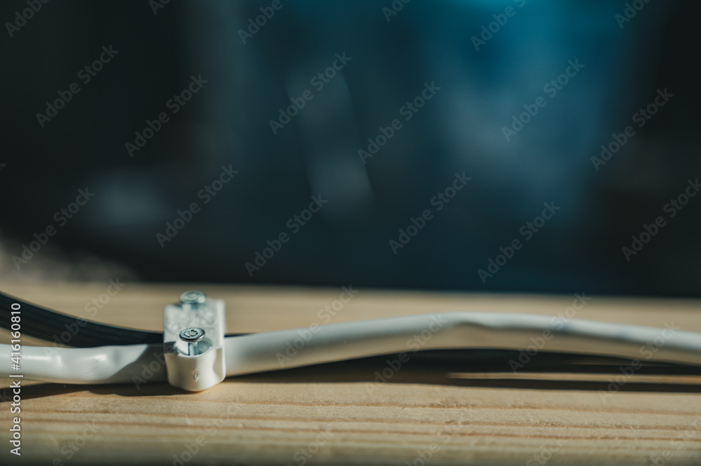 cable staple nailed into a pine board to organize wires cable staple nailed into a pine board to organize wires