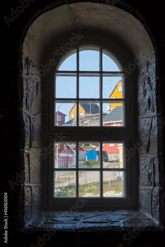 Greenland. Uummannaq. Colorful houses seen from inside the church.