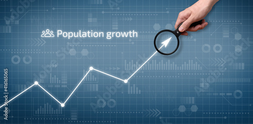 The person points to the graph of population growth on the graphical display