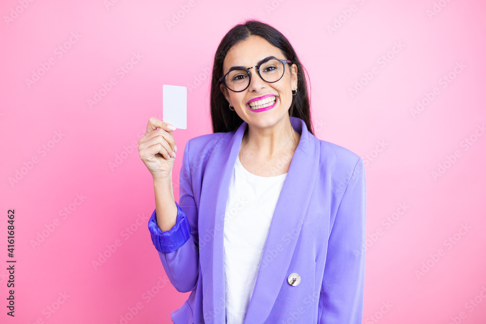 Φωτογραφία Young business woman wearing purple jacket over pink background smiling and hold