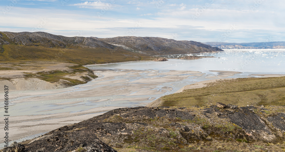 Tundra with braided river and delta near Eqip Glacier in Greenland, Danish Territory. Tundra with braided river and delta near Eqip Glacier in Greenland, Danish Territory.