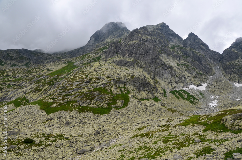 Beautiful landscape to Misty peaks and cloudy mountain Landscape during the day in High Tatras, Slovakia. Adventure Concept