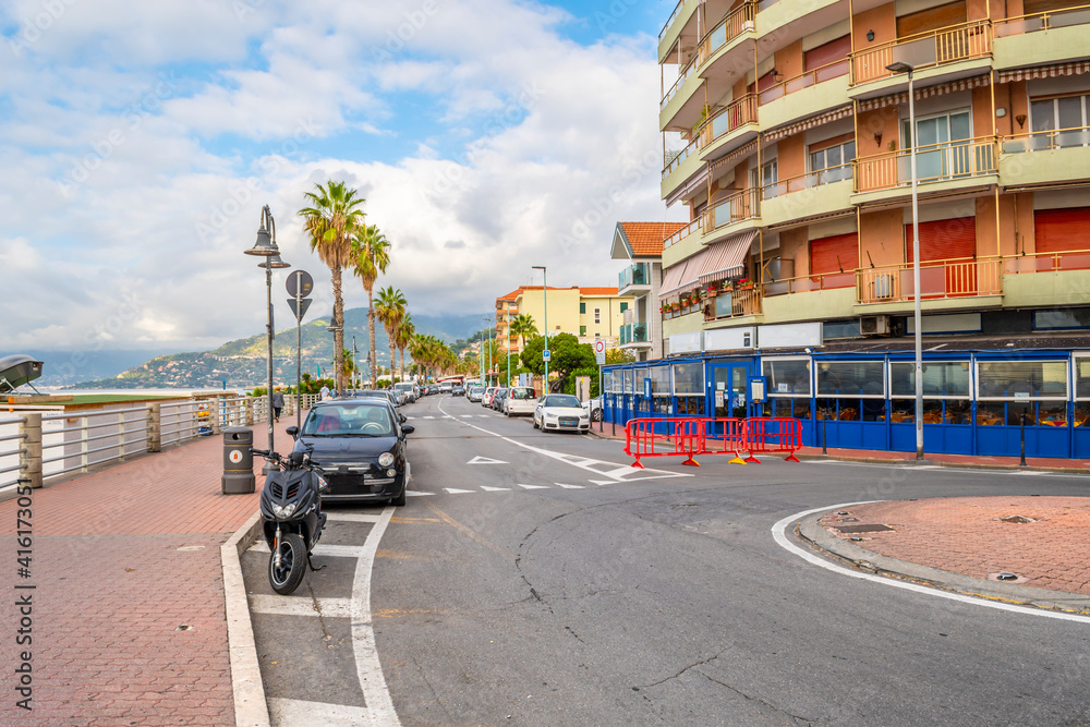 The main coastal road along the Mediterranean sea and beach through the town of Ventimiglia, Italy, in the Imperia region of the Italian Riviera